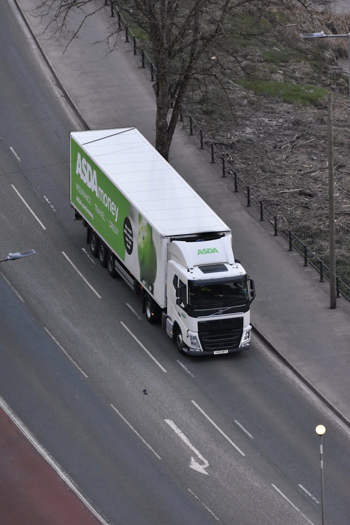 Services High angle view of an ASDA delivery truck driving on an urban street.